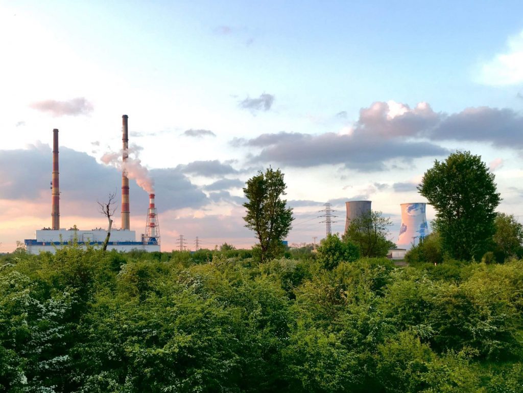 Landscape with trees and power plants at the back
